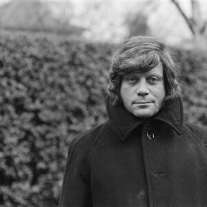 Oliver Reed wearing his wig at his home in Wimbledon, South West, London