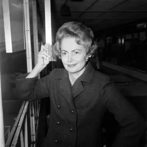 Olivia De Havilland listens to the budget at London Airport while waiting for a flight Olivia De Havilland listens to the budget at London Airport while waiting for a flight