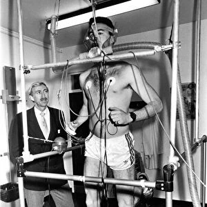 Former Olympic gold medallist David Hemery looks on as Mark McMahon is put through his