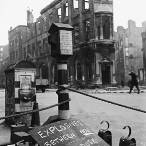 An ominous sign warning of live explosives displaying in a street during the Second World An ominous sign warning of live explosives displaying in a street during the Second World