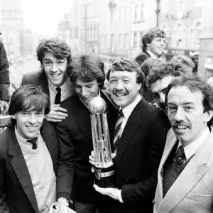 Oxford United footballers with the Second Division Championship trophy on an open top bus