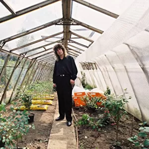 Ozzy Osbourne in his greenhouse in the garden of his home. May 1988