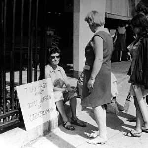 Pacifist campaigner Pat Arrowsmith asitting on the kerb outside the gates of Kensington