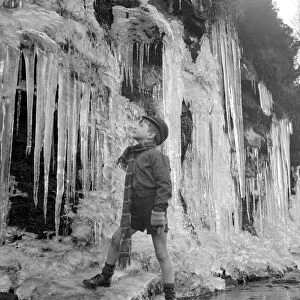 Paddy Lloyd inspects the icicles close to his Derbyshire home December 1952