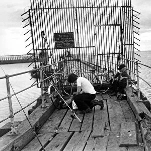 A pair of young anglers prepare to enjoy a quite afternoon fishing on Blyth Pier