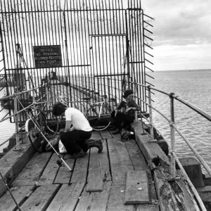 A pair of young anglers prepare to enjoy a quite afternoon fishing on Blyth Pier