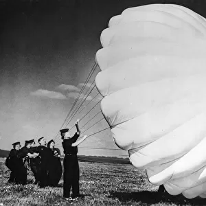 Parachute packers of the W. R. N. S. testing a parachute at a British Naval Air Station