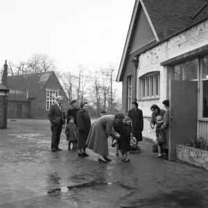 Parents collecting their children from school. 6th December 1957