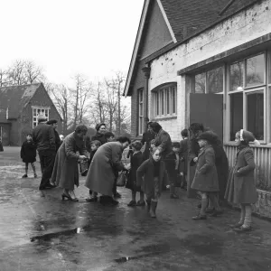 Parents collecting their children from school. 6th December 1957