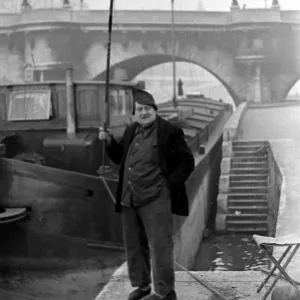 Paris street scenes - Man holding a fishing rod circa 1951