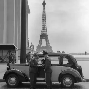 Passenger pays his fare at the end of his journey by the London to Paris taxi service Passenger pays his fare at the end of his journey by the London to Paris taxi service