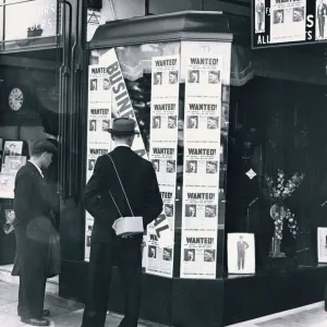 A passer-by look at a tailor shop window plastered with copies of the Daily Mirror Hitler A passer-by look at a tailor shop window plastered with copies of the Daily Mirror Hitler