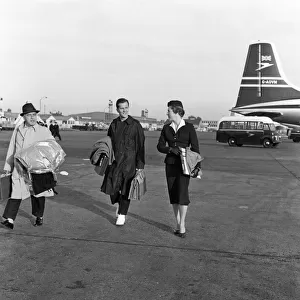 Pat Boone arriving at London Airport. BOAC air receptionist Priscilla walks with him