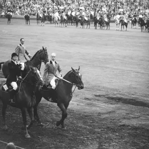 Pat Smythe and two other members of the British Team ride past the Royal box