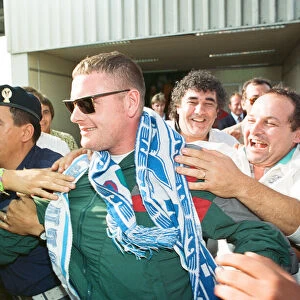 Paul Gascoigne is mobbed by airport workers and Lazio fans on arrival in Rome