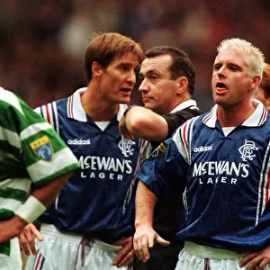 Paul Gascoigne of Rangers makes a face at Paolo di Canio of Celtic with Richard Gough