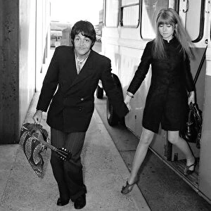 Paul McCartney of the Beatles and girlfriend Jane Asher get off the bus at their stop