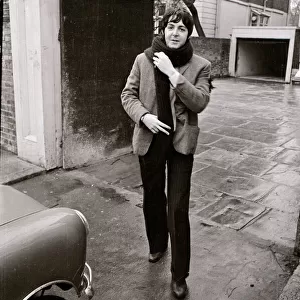 Paul McCartney of the Beatles about to get into his mini car December 1967