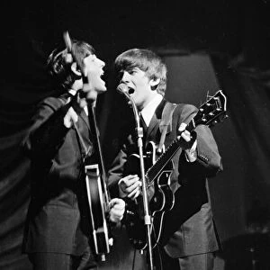Paul McCartney and George Harrison of The Beatles performing on stage in Carlisle