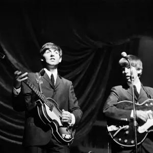 Paul McCartney and George Harrison of The Beatles performing on stage in Carlisle