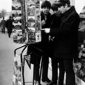 Paul McCartney, George Harrison and John Lennon of the Beatles pop group looking Paul McCartney, George Harrison and John Lennon of the Beatles pop group looking
