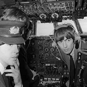 Paul McCartney, George Harrison and Ringo Starr in the cockpit on the plane bound for