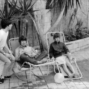 Paul McCartney, George Harrison and Ringo Starr relax on sun loungers at their rented Paul McCartney, George Harrison and Ringo Starr relax on sun loungers at their rented