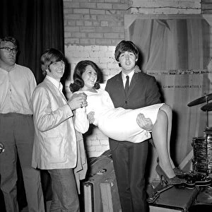 Paul McCartney holding Cherry Rowland as Ringo Starr watches at the Futurist theatre in