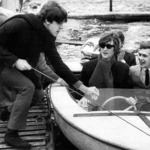 Paul McCartney pulls a boat into the jetty which John Lennon had been out on Loch Earn