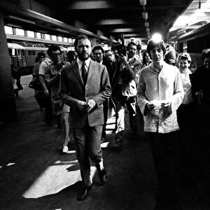 Paul McCartney walking along the platform to his awaiting train as The Beatles leave
