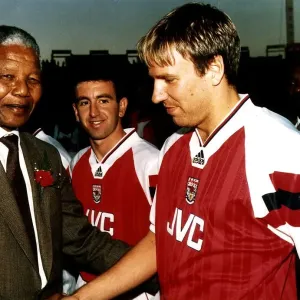 Paul Merson, football player for Arsenal FC, shakes hands with the President of South Paul Merson, football player for Arsenal FC, shakes hands with the President of South