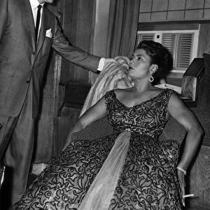 Pearl Bailey, the coloured singer, leaned back in her chair in a dressing room at