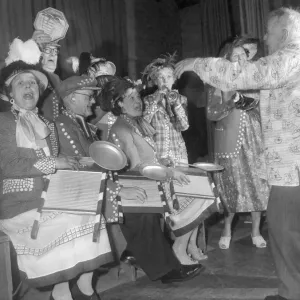 Pearly kings and queens play the washboard and other musical instruments during a concert Pearly kings and queens play the washboard and other musical instruments during a concert