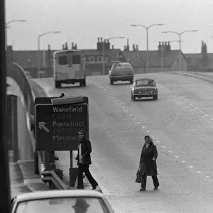 People crossing the motorway dangerously, in the north of England. 11th November 1974