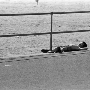 People enjoying a day at Crosby beach. A young boy sunbathing. Crosby, Merseyside