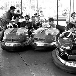 People enjoying the dodgems ride at Hearsall Common fair, Coventry. 3rd June 1963