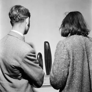 People examining pieces of art at the Exhibition of Sculpture at Burlington Galleries