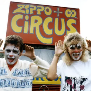 Two people with their faces painted like clowns, pulling funny faces, at the Zippo & Co Two people with their faces painted like clowns, pulling funny faces, at the Zippo & Co