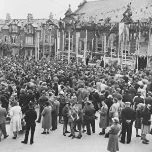 The people of Paignton gather outside the Palace Avenue Theatre in May 1945 to celebrate