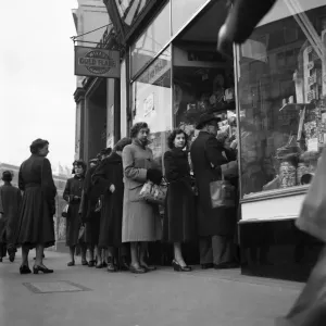 People queuing up outside a confectioney shop after sweets came off the ration following People queuing up outside a confectioney shop after sweets came off the ration following