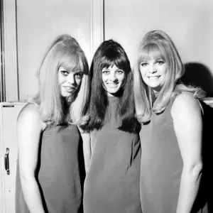 People Women: Three girls wearing mini dresses smile into the camera People Women: Three girls wearing mini dresses smile into the camera