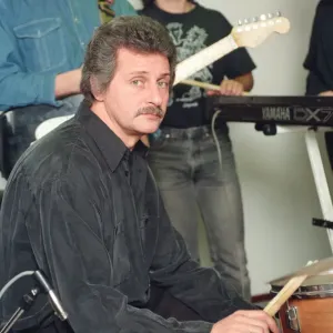 Pete Best, (in the black shirt holding his drum sticks) posing for the camera with his