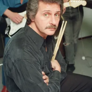 Pete Best, (in the black shirt holding his drum sticks) posing for the camera with his