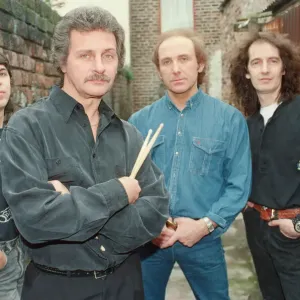 Pete Best, (in the black shirt holding his drum sticks) posing for the camera with his
