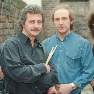 Pete Best, (in the black shirt holding his drum sticks) posing for the camera with his