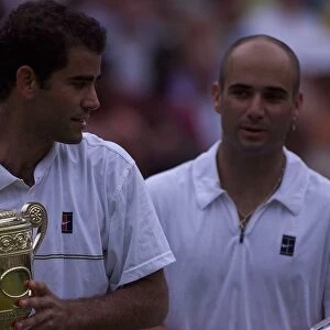 Pete Sampras with trophy watched by Andre Agassi after Pete had won the Mens Final
