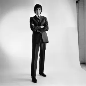 Pete Townshend of British rock group The Who, poses in the studio wearing suit and tie Pete Townshend of British rock group The Who, poses in the studio wearing suit and tie