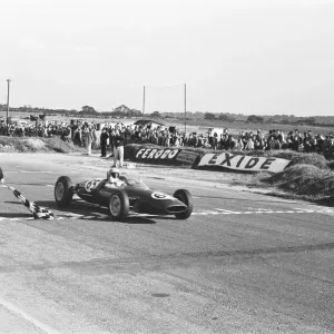 Peter Arundell in his Lotus 22 takes the checkered flag to win the Molyslip Trophy / IV Peter Arundell in his Lotus 22 takes the checkered flag to win the Molyslip Trophy / IV