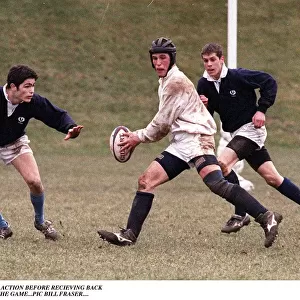 Peter Phillips playing rugby wearing head support holding ball