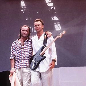 Phil Collins and Sting stand on the stage at Live Aid Charity concert at Wembley Stadium